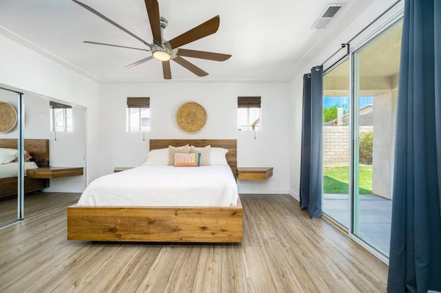 bedroom with ceiling fan, access to exterior, and light hardwood / wood-style flooring