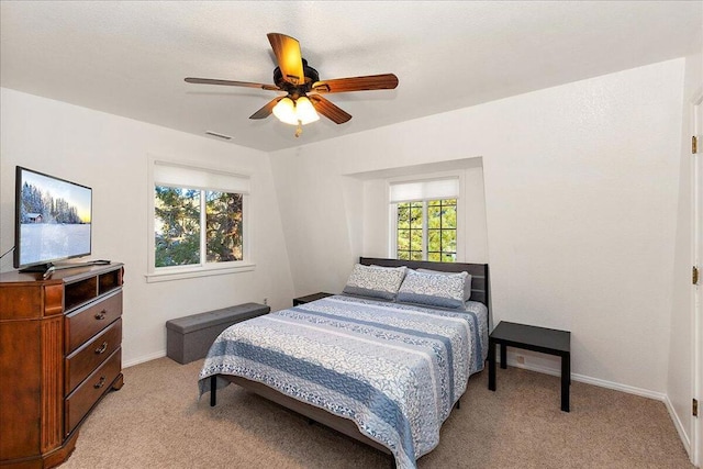 bedroom featuring ceiling fan and light colored carpet