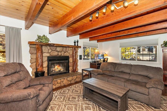 living room featuring beam ceiling, wood ceiling, and a stone fireplace