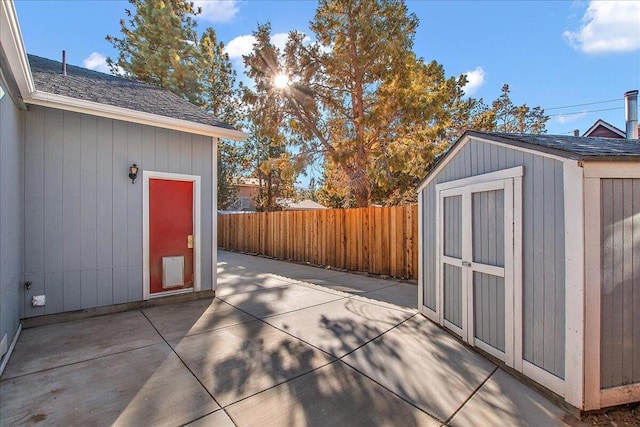 view of patio featuring a shed