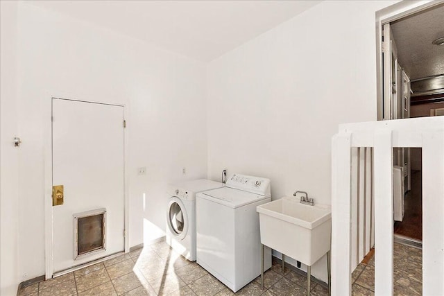 clothes washing area with sink and separate washer and dryer