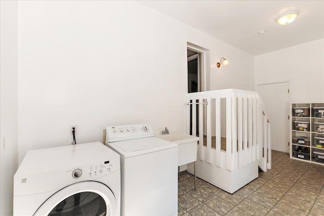 clothes washing area with sink and washing machine and clothes dryer