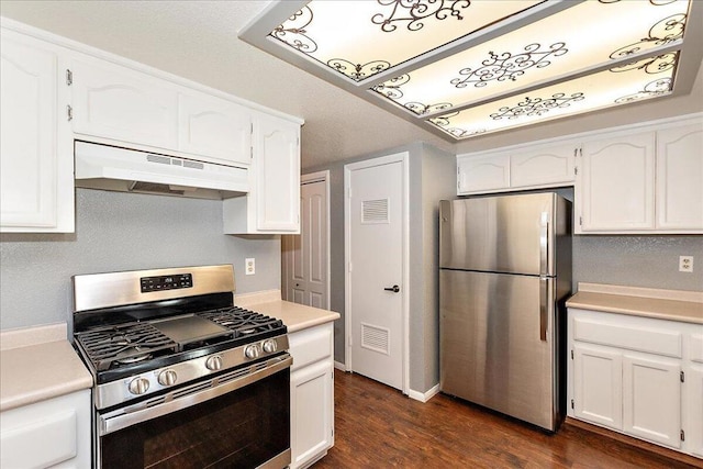 kitchen with dark wood-type flooring, white cabinets, appliances with stainless steel finishes, and range hood