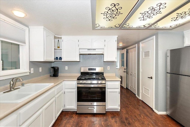 kitchen featuring dark hardwood / wood-style floors, sink, appliances with stainless steel finishes, a textured ceiling, and white cabinets