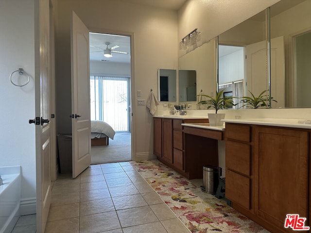 bathroom featuring ceiling fan, tile patterned flooring, vanity, and a bathing tub