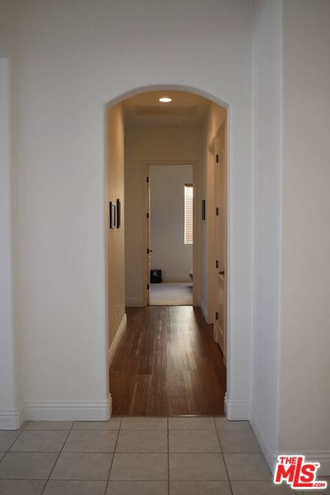 hallway featuring light tile patterned flooring