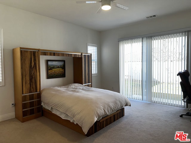 carpeted bedroom with ceiling fan and access to exterior