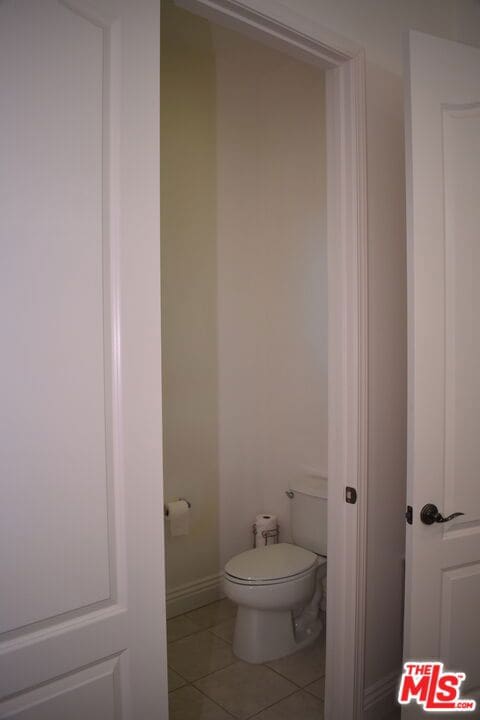 bathroom with toilet and tile patterned flooring