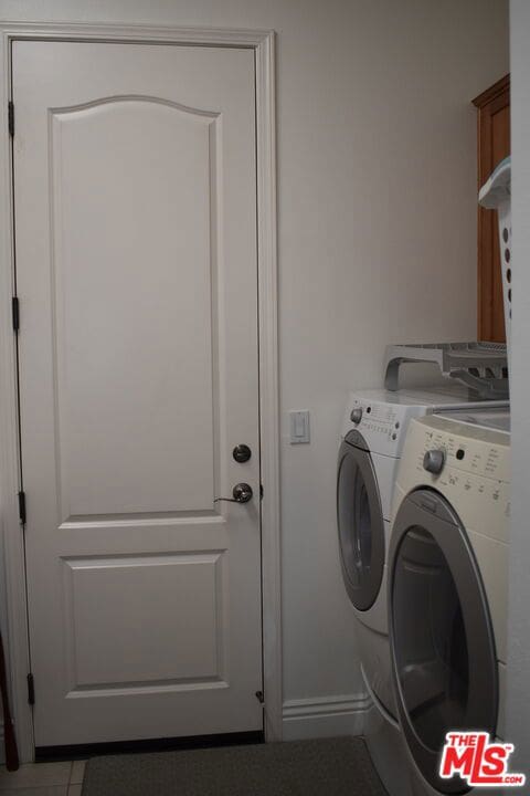 washroom with washer and dryer and tile patterned flooring