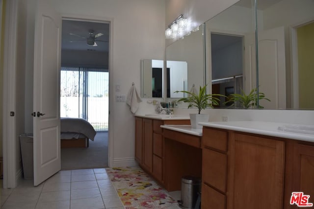 bathroom featuring tile patterned flooring, ceiling fan with notable chandelier, and vanity