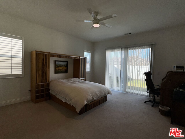 carpeted bedroom with ceiling fan and access to exterior