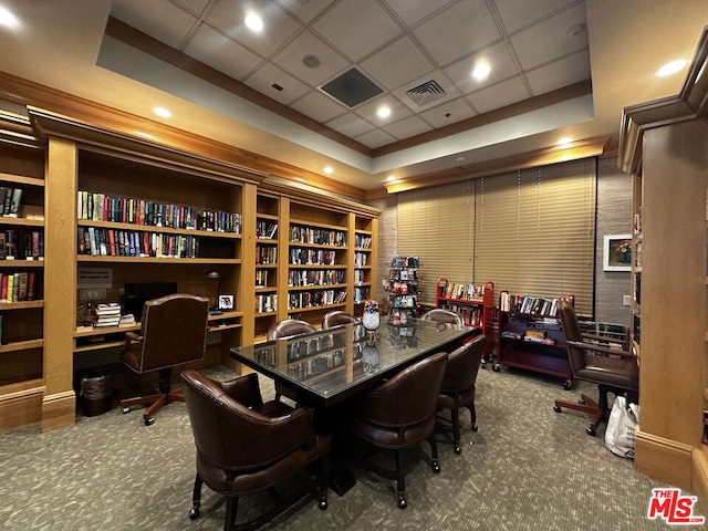 dining room with carpet floors, built in shelves, and a paneled ceiling