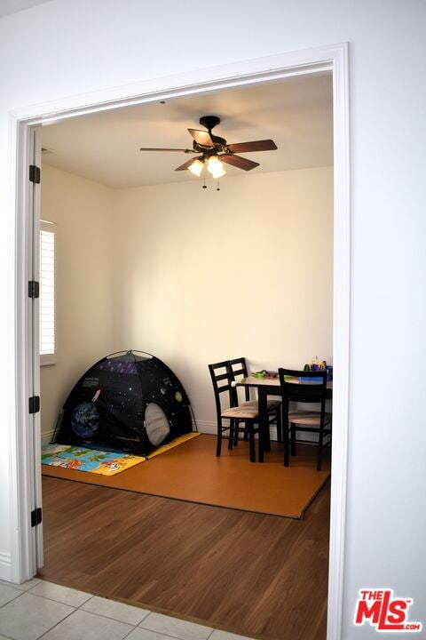 tiled dining space featuring ceiling fan