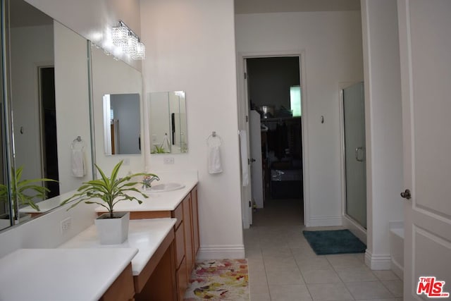 bathroom featuring tile patterned floors, vanity, an inviting chandelier, and shower with separate bathtub