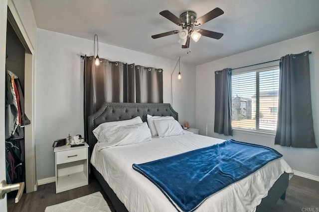 bedroom with dark hardwood / wood-style flooring and ceiling fan