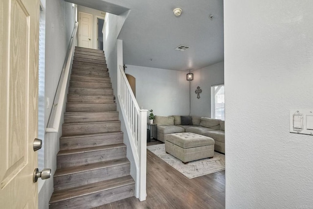 stairs featuring wood-type flooring