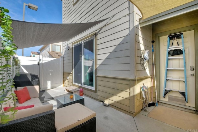 view of side of home featuring outdoor lounge area and a patio area