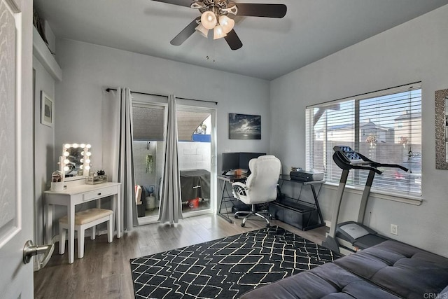 interior space with ceiling fan and wood-type flooring