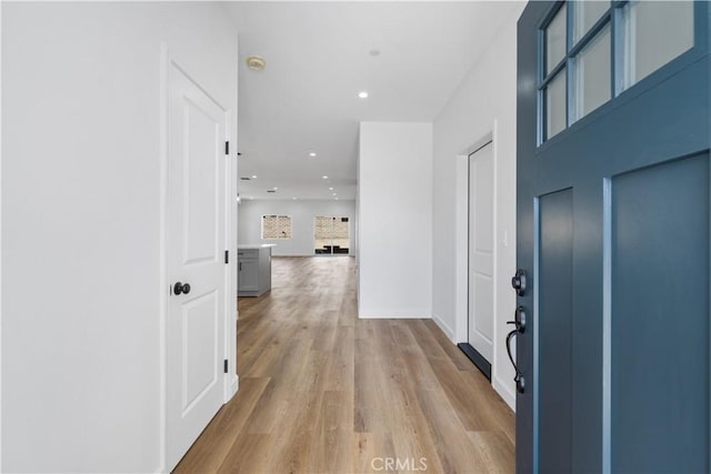 corridor with light hardwood / wood-style floors