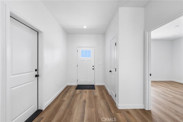 doorway to outside featuring wood-type flooring