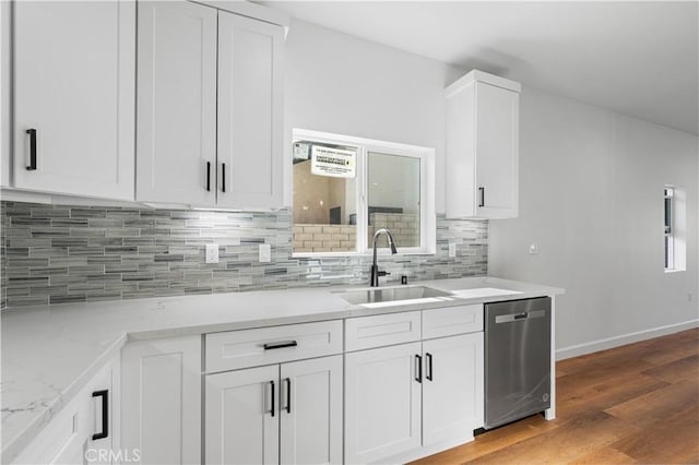 kitchen featuring white cabinets, wood-type flooring, sink, light stone counters, and stainless steel dishwasher