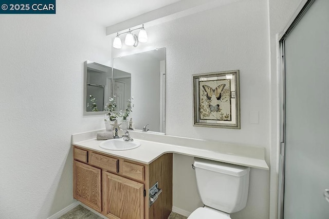 bathroom featuring vanity, toilet, and a shower with door