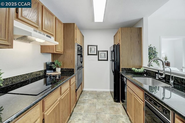 kitchen featuring dark stone countertops, ventilation hood, black appliances, and sink