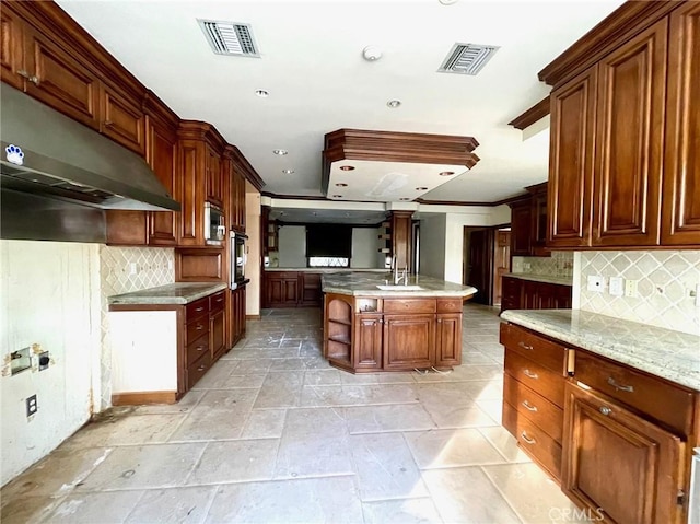 kitchen featuring a center island, tasteful backsplash, sink, wall oven, and crown molding