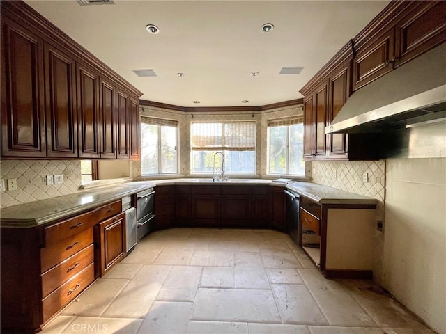 kitchen with extractor fan, tasteful backsplash, sink, ornamental molding, and stainless steel dishwasher