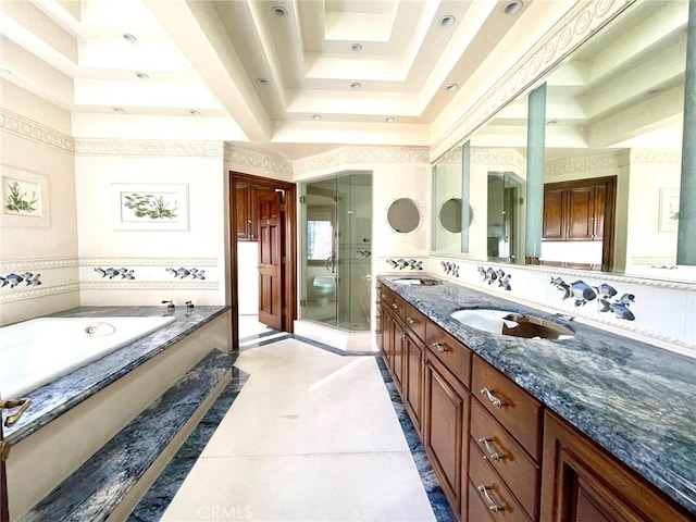 bathroom featuring tile patterned flooring, a tray ceiling, separate shower and tub, and vanity