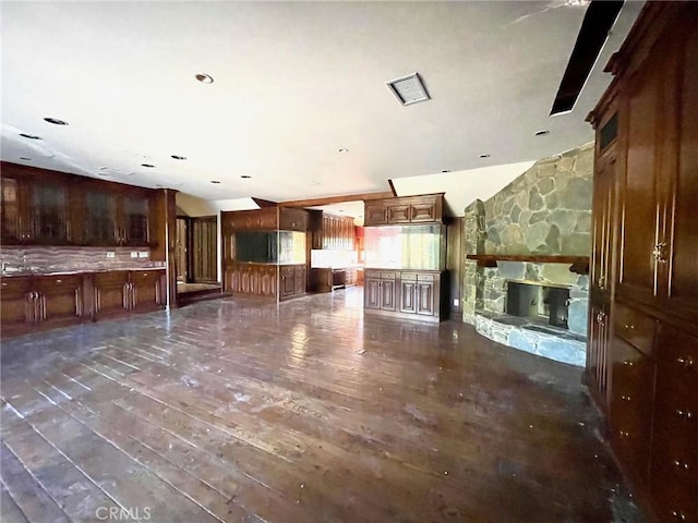 unfurnished living room with a stone fireplace