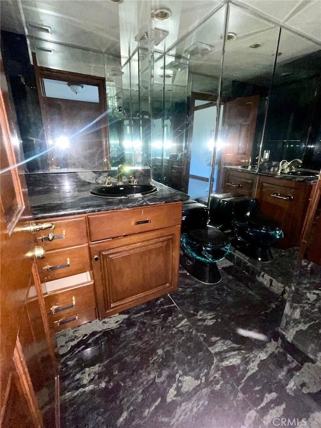 bathroom featuring toilet and vanity