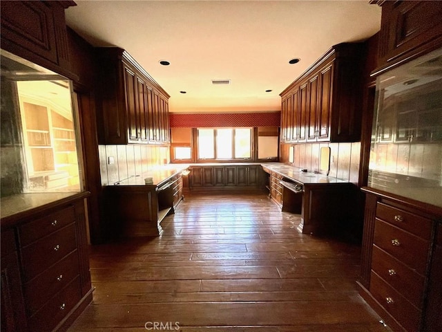 kitchen with dark hardwood / wood-style floors and dishwashing machine