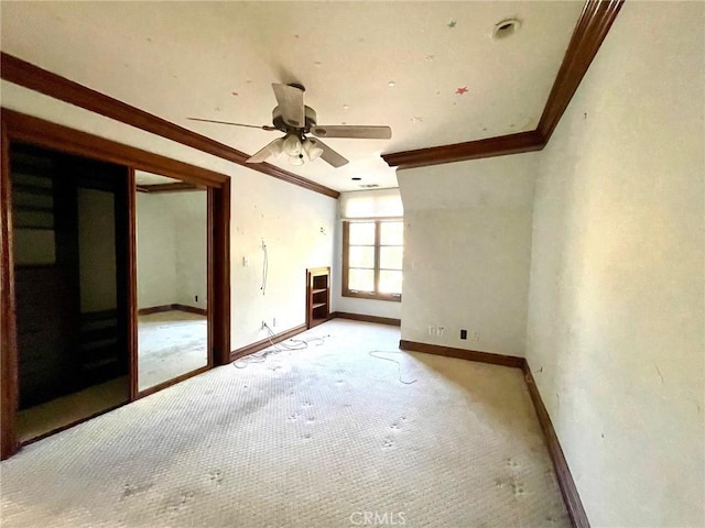 empty room with ceiling fan and ornamental molding