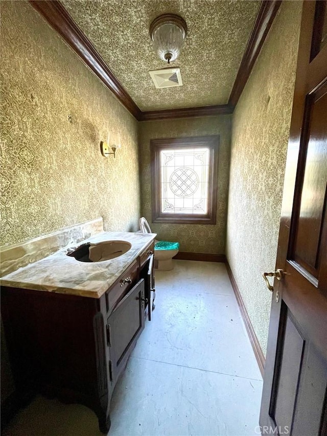 bathroom with toilet, vanity, crown molding, and concrete flooring