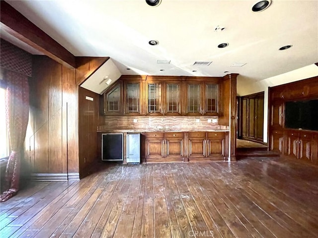 kitchen with dark hardwood / wood-style floors, refrigerator, and tasteful backsplash