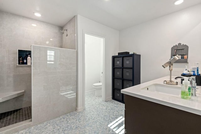 full bath with double vanity, baseboards, toilet, walk in shower, and recessed lighting