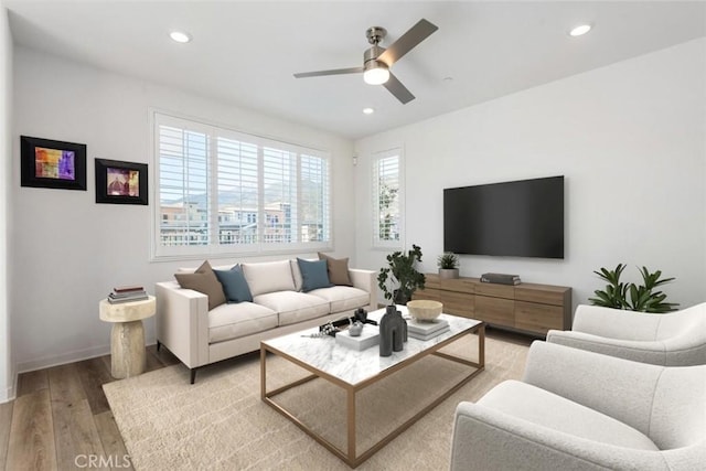 living room with light wood finished floors, ceiling fan, baseboards, and recessed lighting