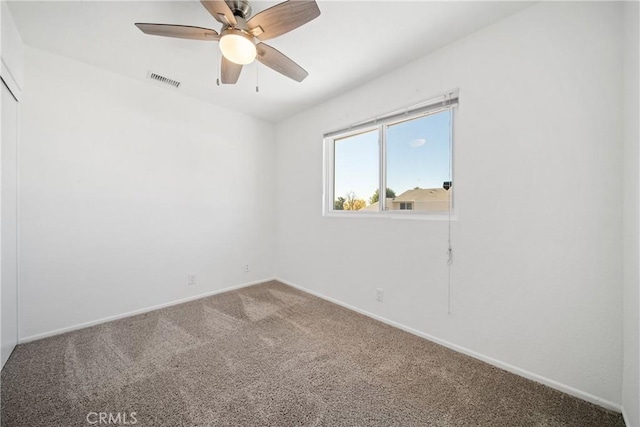 spare room with ceiling fan and carpet floors