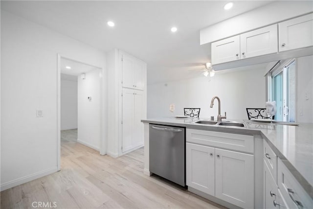 kitchen featuring white cabinetry, ceiling fan, light wood-type flooring, dishwasher, and sink