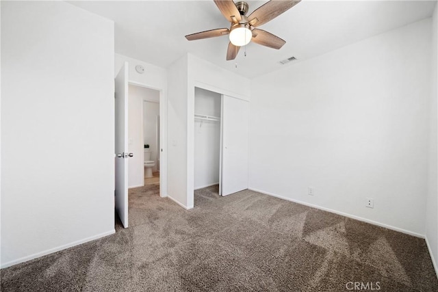 unfurnished bedroom featuring ceiling fan, a closet, and light carpet