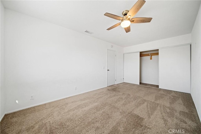 unfurnished bedroom with ceiling fan, a closet, and carpet floors