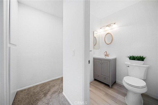 bathroom featuring toilet and vanity