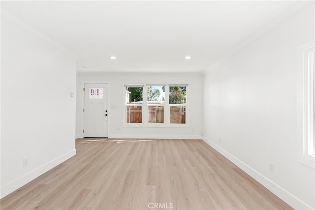 interior space with ornamental molding and light hardwood / wood-style flooring