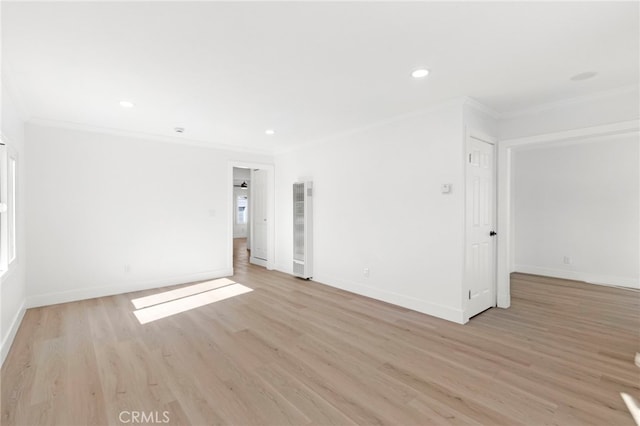 empty room featuring crown molding and light hardwood / wood-style flooring