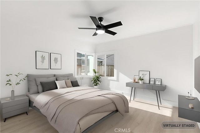 bedroom with light wood-type flooring and ceiling fan