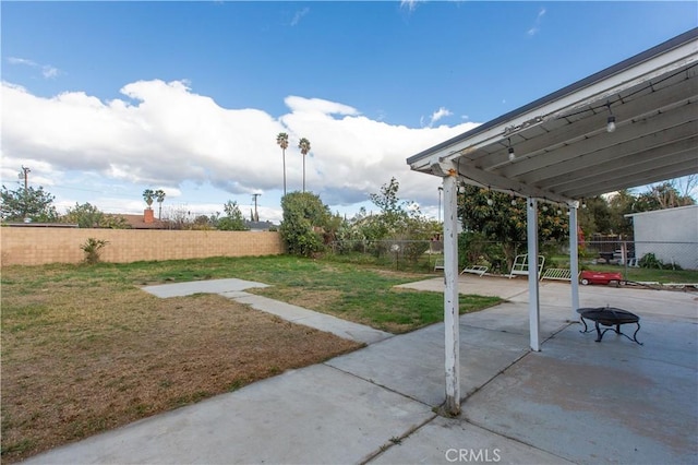 view of yard featuring a patio area and a fire pit