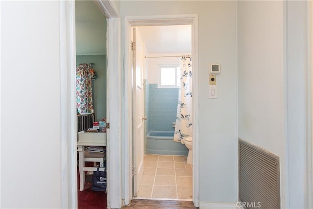 corridor featuring light tile patterned flooring