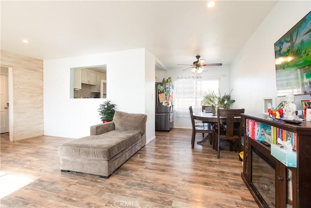 living room with ceiling fan and hardwood / wood-style flooring