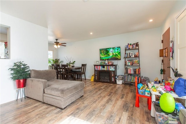 living room with ceiling fan and hardwood / wood-style flooring